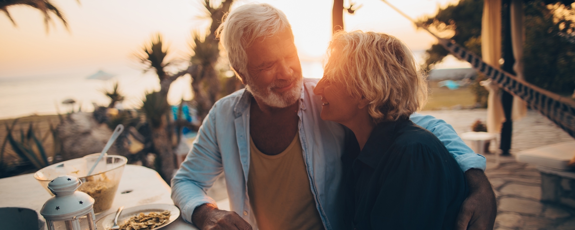 Senior couple having dinner at the beach